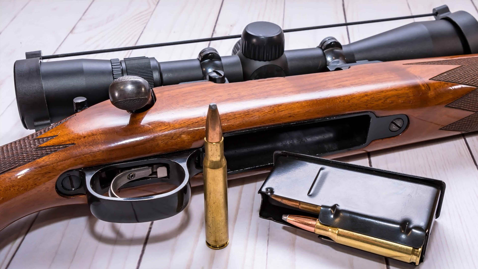 Bolt action rifle with ammo and mag on table