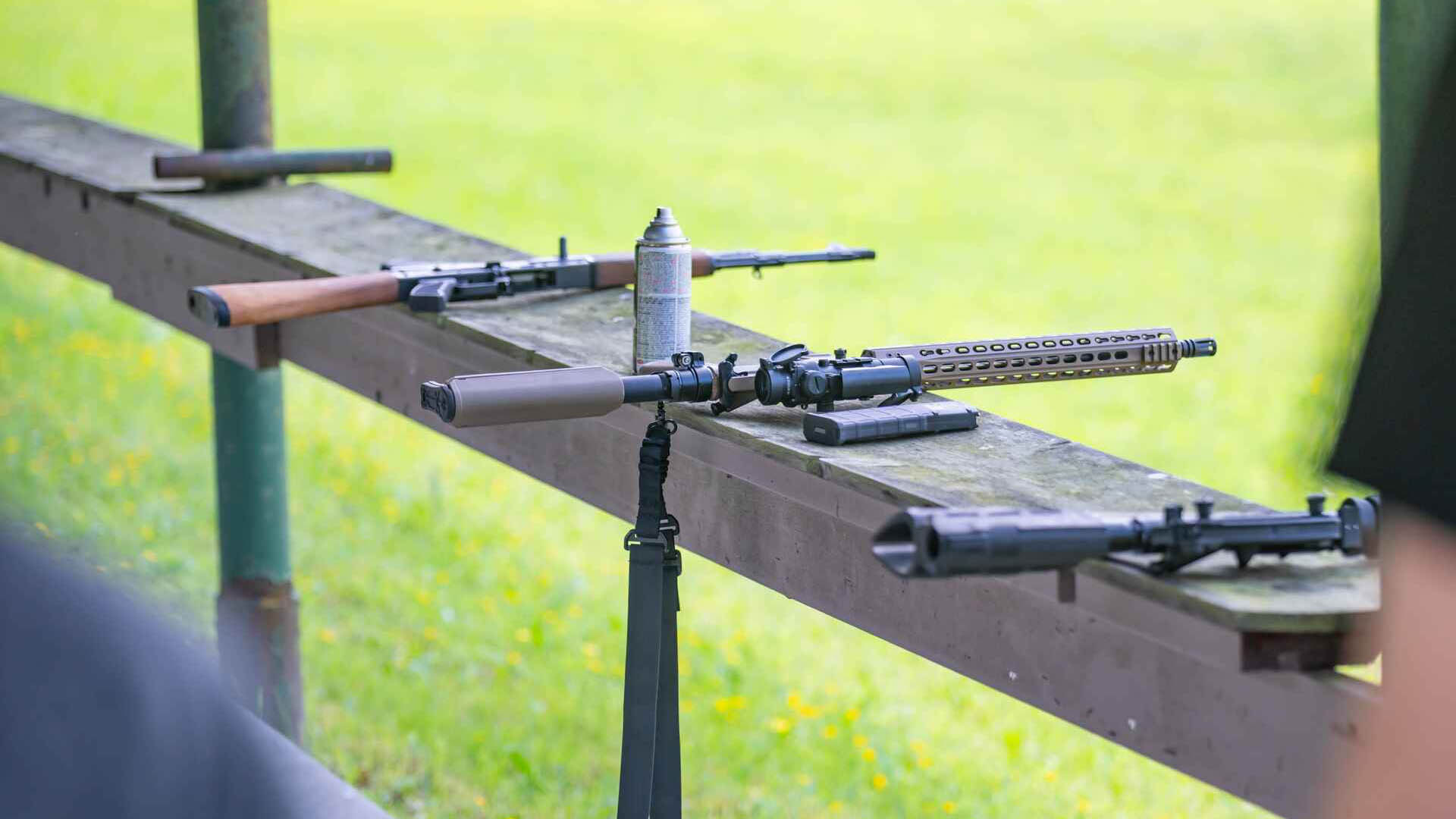 rifles on a table at a shooting range